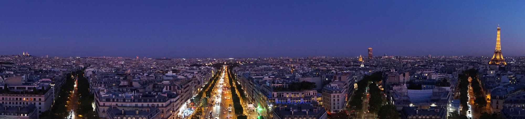 An aerial view of Paris at night from the top of the Arc de Triomphe.