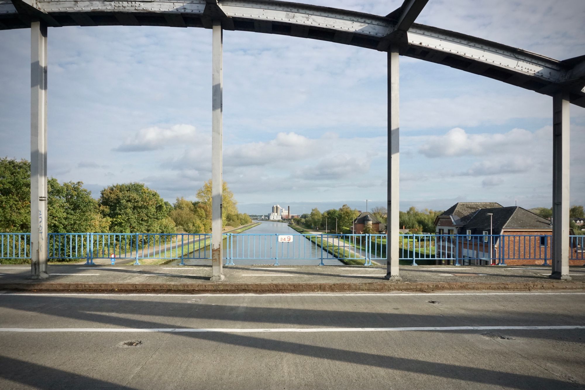 From the deck of a metal bridge over a canal.