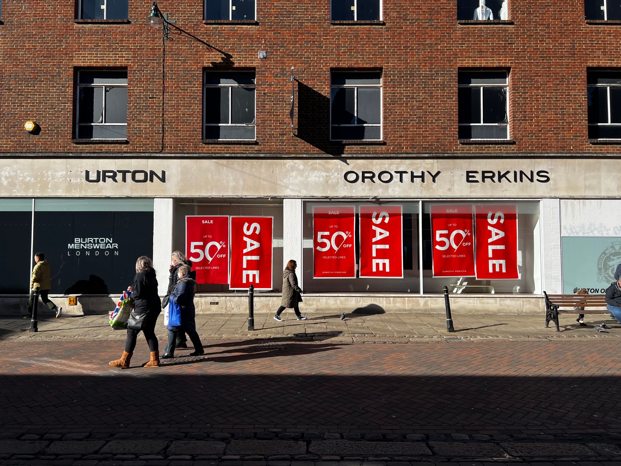 A closed down shop, sale posters still visible in the windows and letters missing from the signage that now reads URTON OROTHY ERKINS.