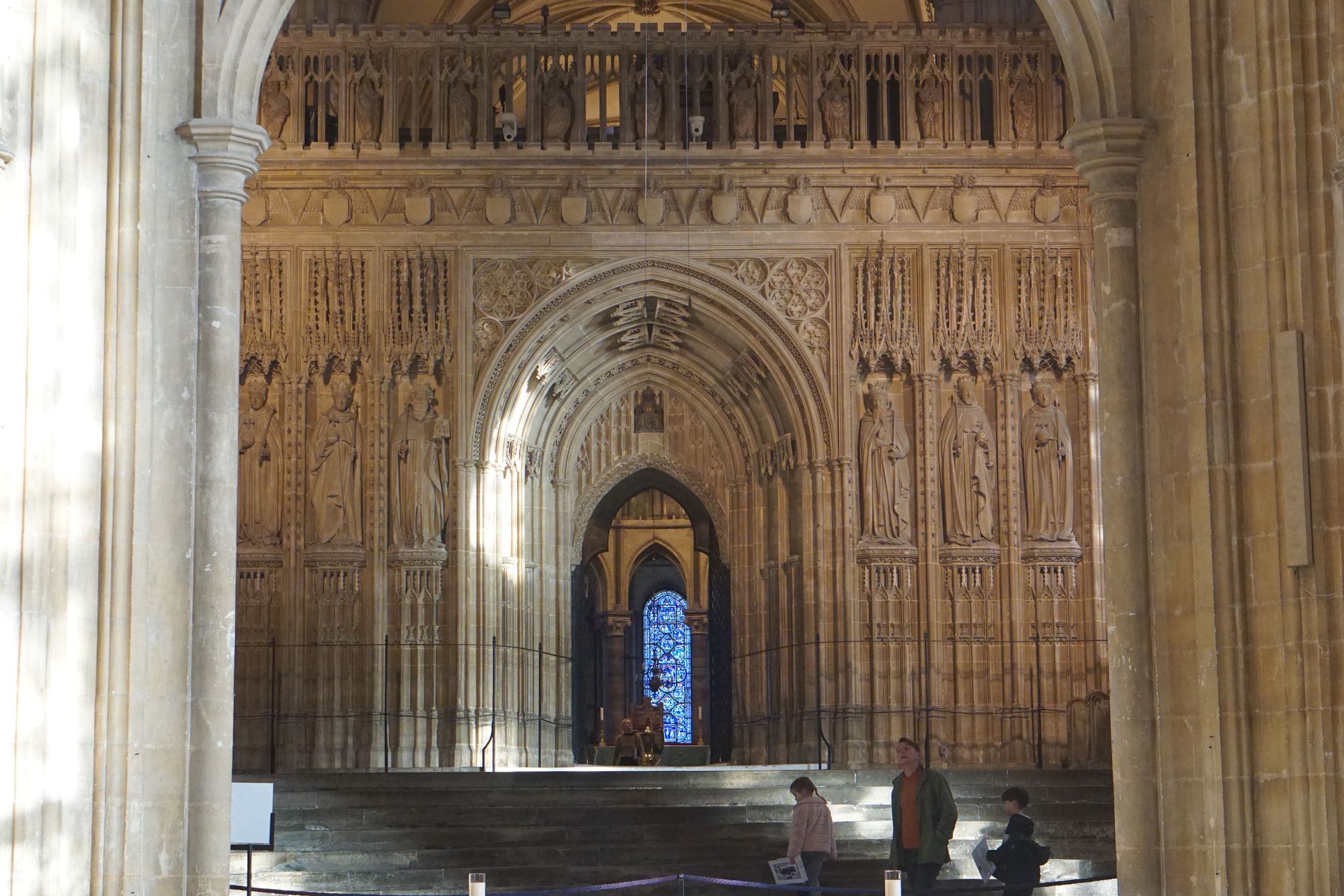 Massive steps leading up to an arch with ornate stone carvings on all sides.