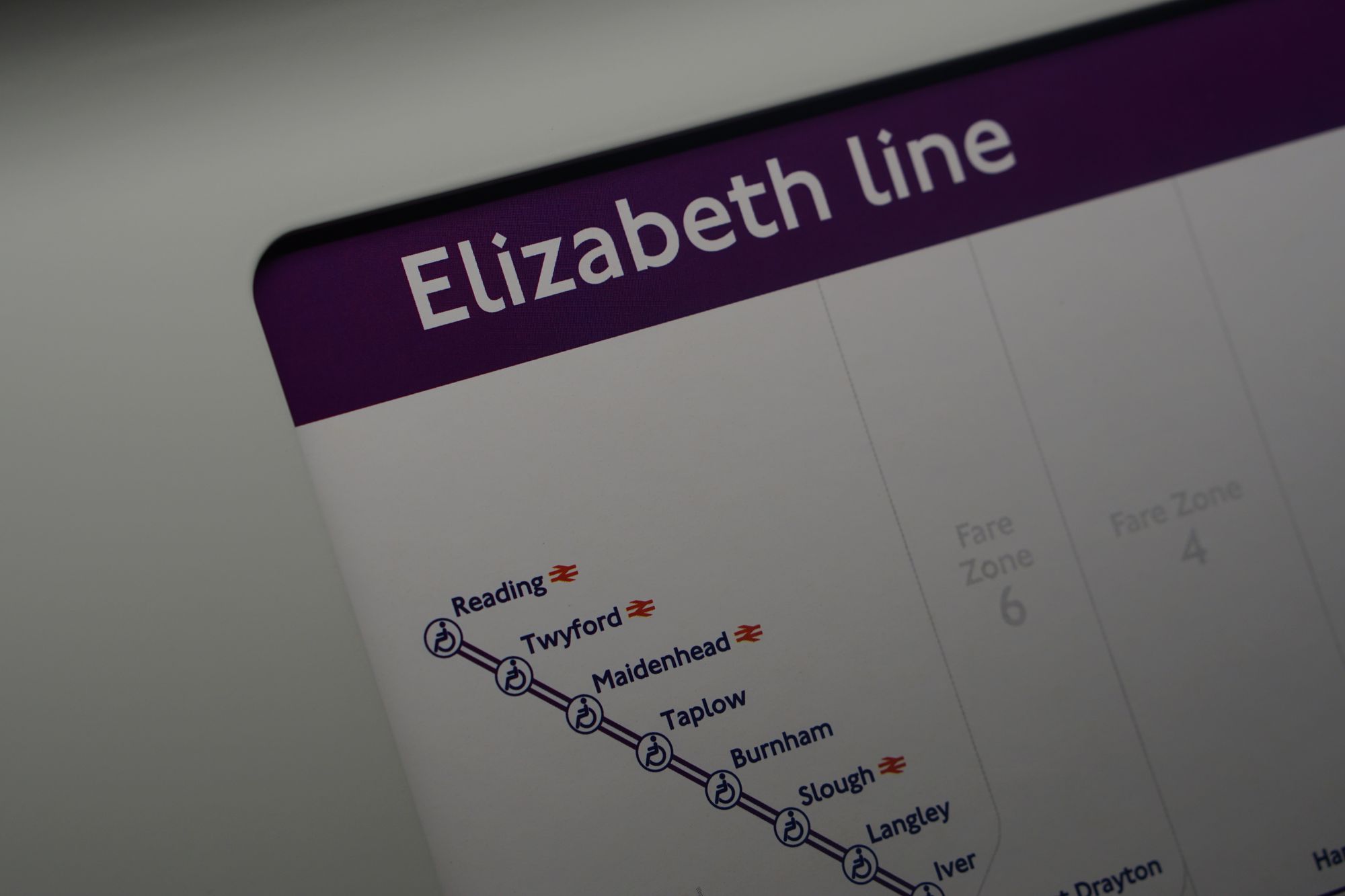 The corner of a map of the Elizabeth Line from inside a train, showing the stations from Iver to Reading.