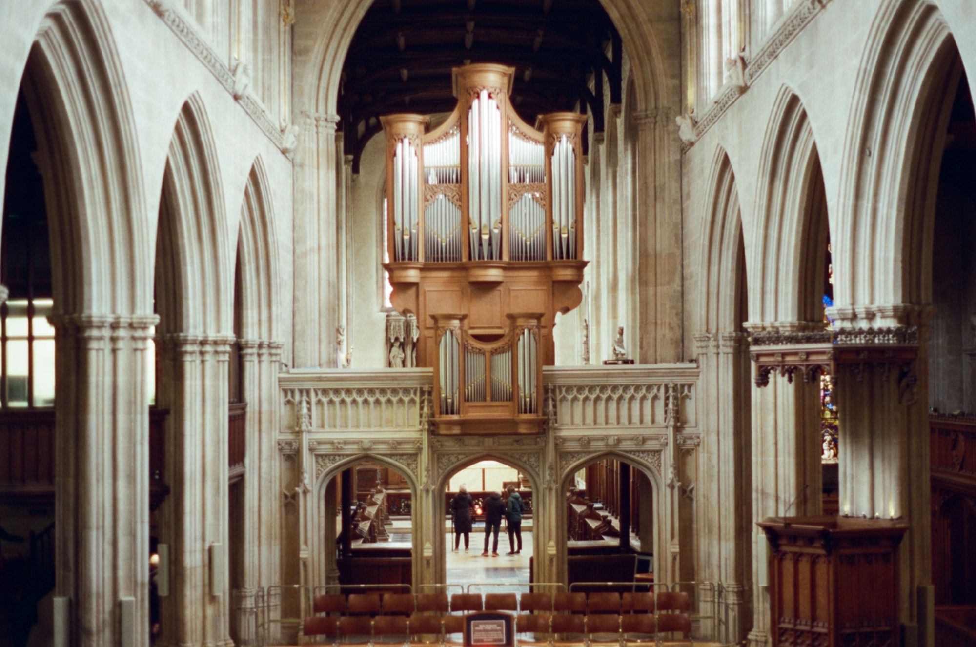 A grand pipe organ in an old church, its silver pipes gleaming.